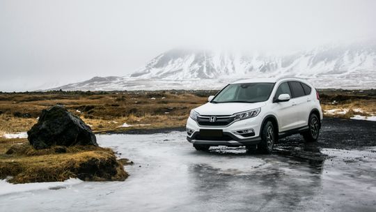 white Honda SUV on gray floor